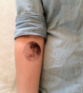 Realistic colors moon tattoo on arm