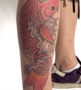 Red adorable fish tattoo on leg