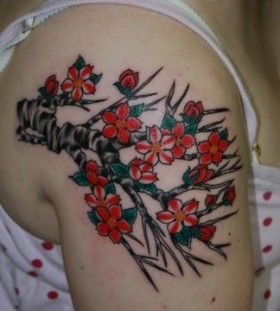 Red and black cherry tattoo on arm