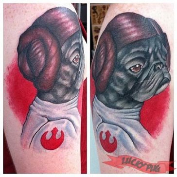Red and black dog tattoo on arm