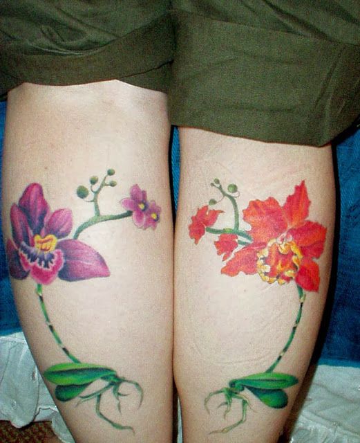 Red and purple flower tattoo on leg