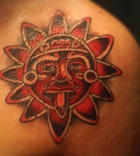 Red lovely sun tattoo on shoulder