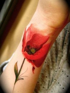 Red tulip tattoo on hand