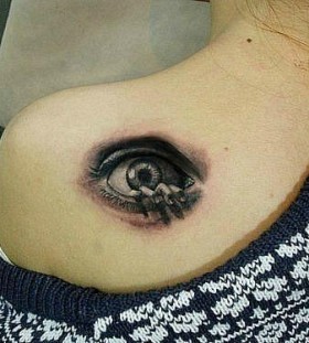 Scary hand and eye tattoo on shoulder