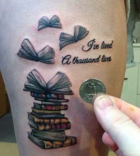 Simple quotes and book tattoo on arm