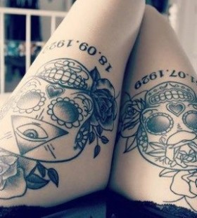 Skull and black flower tattoo on leg