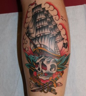 Skull and lovely ship tattoo on leg