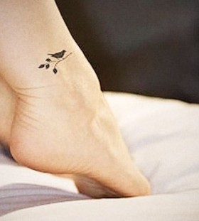 Small black bird tattoo