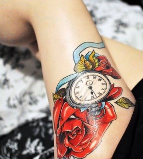Watch and red rose tattoo on leg
