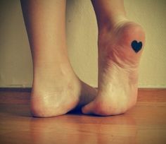 Black heart girl tattoo on foot