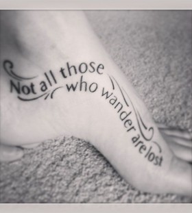 Black quote girl tattoo on foot