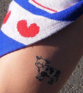 Blue and white cow tattoo