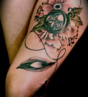 Gorgeous flowers compass tattoo on leg