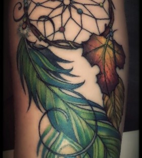Green feather and yellow leaf peacock tattoo