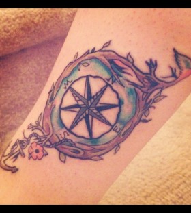 North, south, west compass tattoo on leg