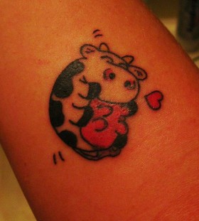 Red heart and cow tattoo