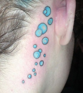 Women ear blue bubbles tattoo