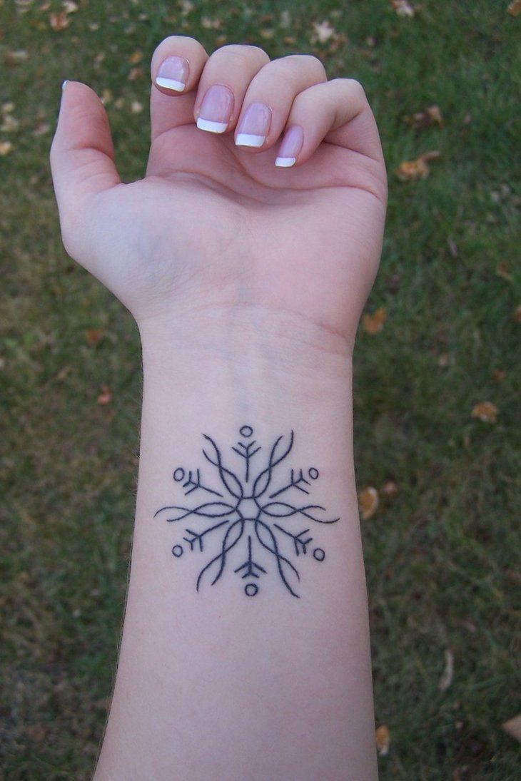 black snowflake tattoo on wrist - TattooMagz