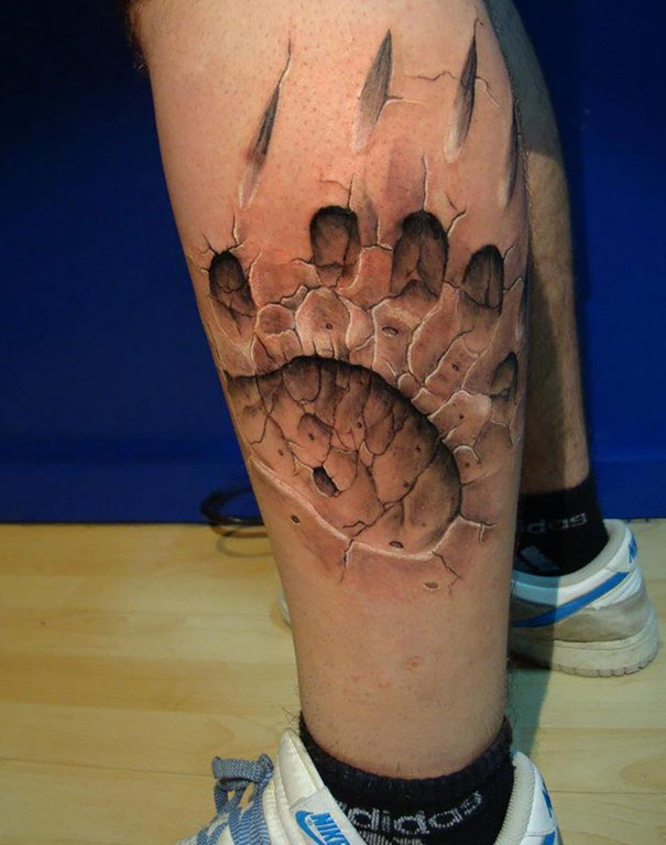 3D claw print on calf tattoo