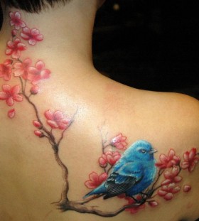 Blue bird and cherry blossom branch tattoo