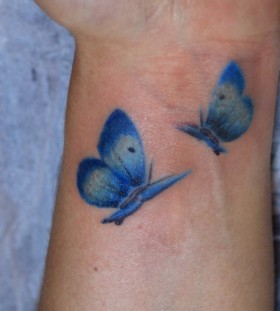 Blue wrist watercolor butterfly tattoo