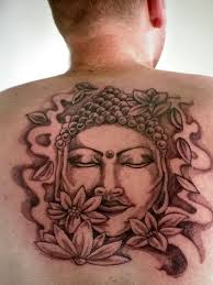 Buddha and flowers tattoo