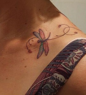 Colourful dragonfly collarbone tattoo