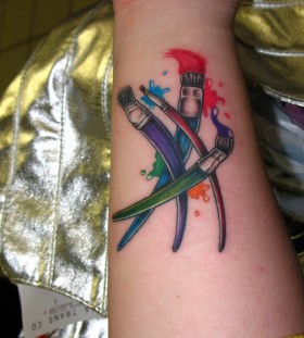 Colourful paint brushes tattoo
