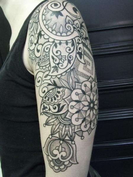 Indian inspired upper arm flower tattoo