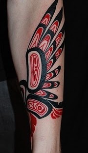 Red feather and tribal bird tattoo