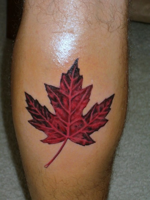 Red maple leaf leg tattoo