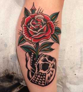 Rose growing from skull tattoo by Nick Oaks