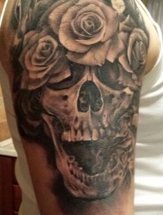 Skull and roses arm tattoo by Razvan Popescu