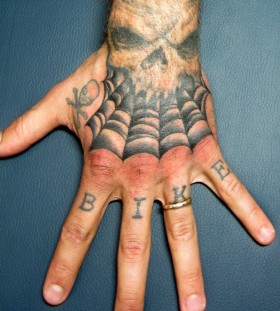 Skull and spider web hand tattoo