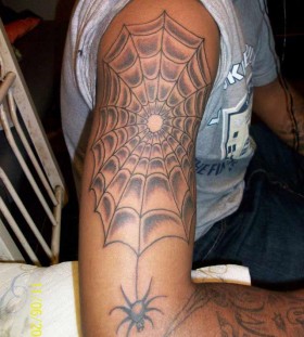 Spider web arm tattoo
