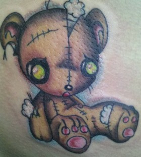 Torn teddy bear tattoo