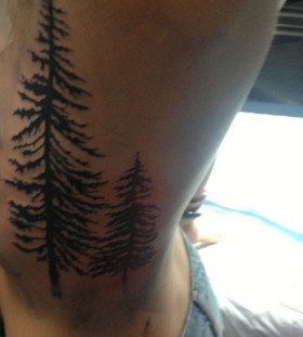 Two pine trees side tattoo