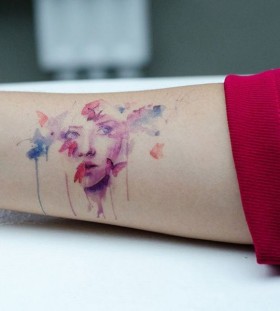 Woman's face and watercolor butterfly tattoo