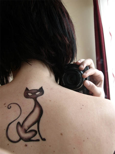 Sleek Black Cat Tattoo on Upper Back