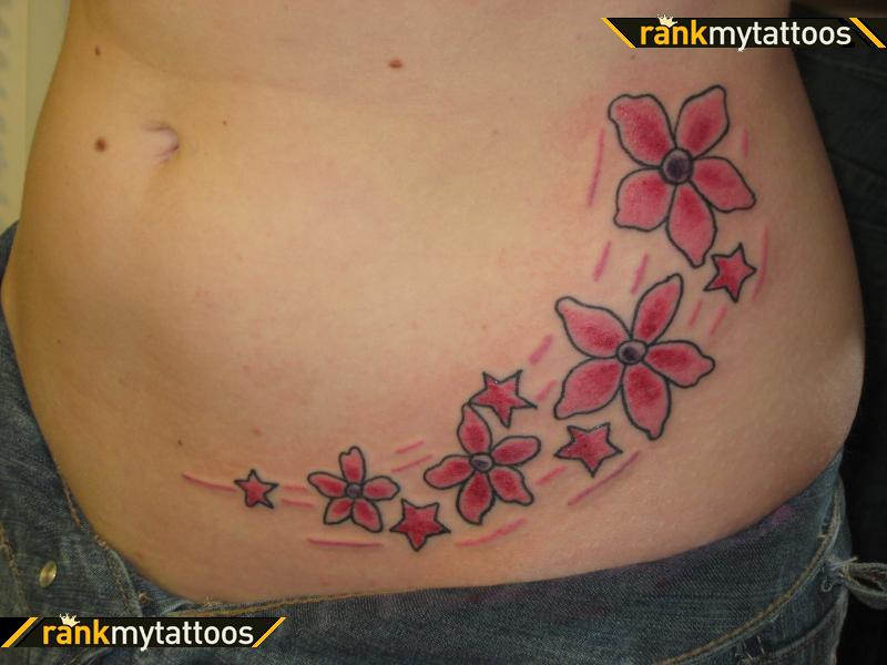 Red Stars And Flowers Tattoo On Hip
