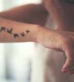 Fantastical Picture Of Flying Bird Silhouette Arm Tattoo Design