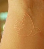 Cute Flying Bird White Ink Tattoo