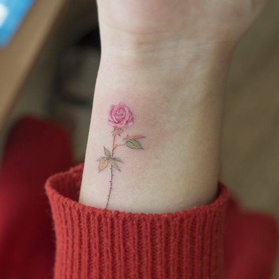 pink rose wrist flower tattoo
