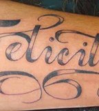Felicity Name in Swirly Design Tattoo on Outer Lower Hand