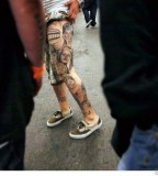 Man with Left Leg Tattoo artist at Ink Slinger Tattoo
