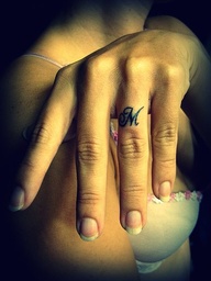 Awesome M Shaped Tattoo Design on Ring Finger
