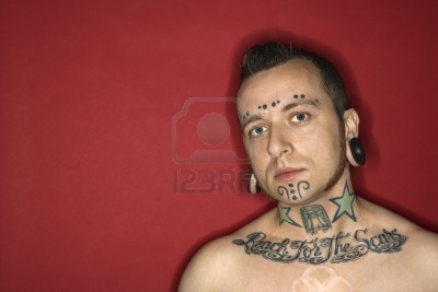 Man With Necklace / Chest / Face Tattoos And Piercings