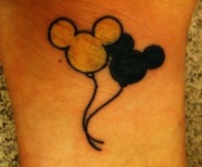Mickey Mouse tattoo on arms