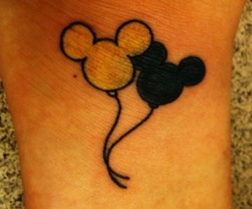 Mickey Mouse tattoo on arms