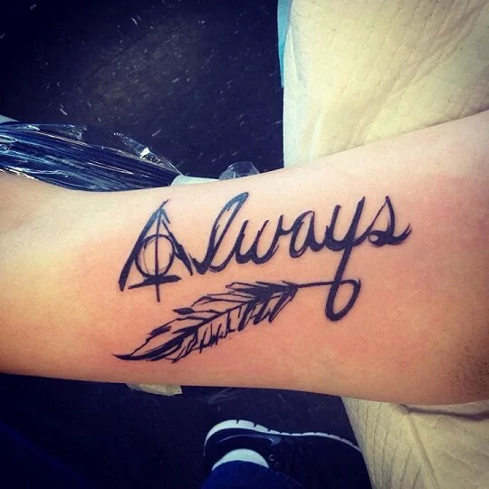 The deathly hallows feather tattoo